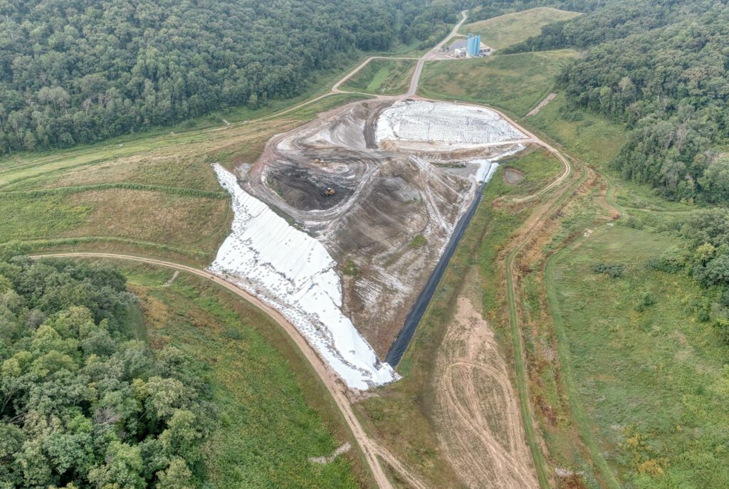 Aerial view of a construction site near Alma, WI, showing landscape and industrial development.